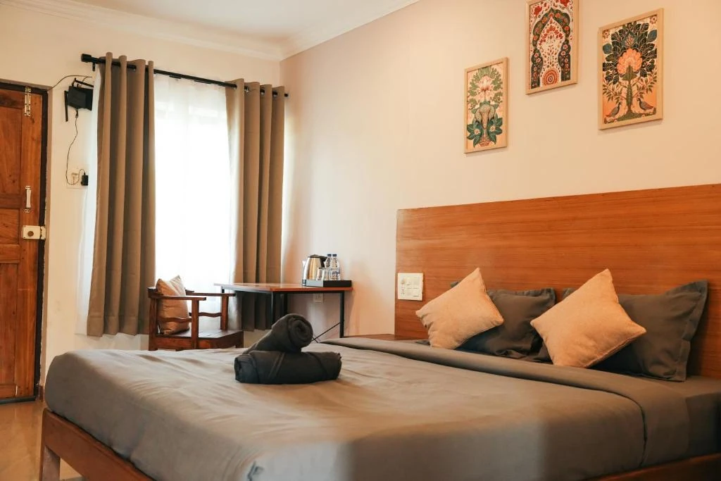 A bright guest room at North39 in Mandrem, with a double bed and wooden furnishings
